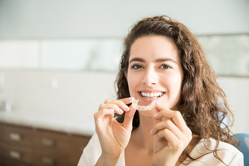 Women holding clear aligners at Highridge Dental Care in Folsom, CA